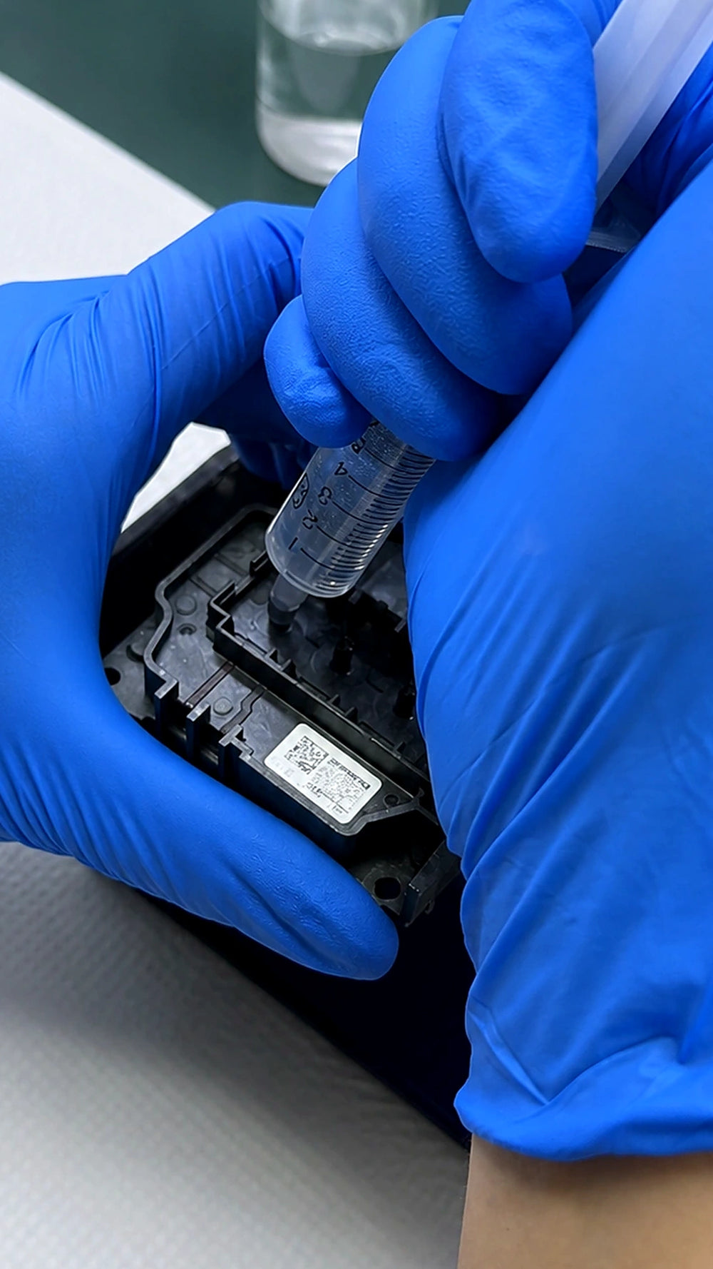 Technician manually cleaning an Epson industrial printhead